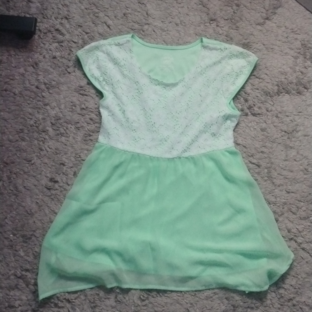 A green top with a floral design on top